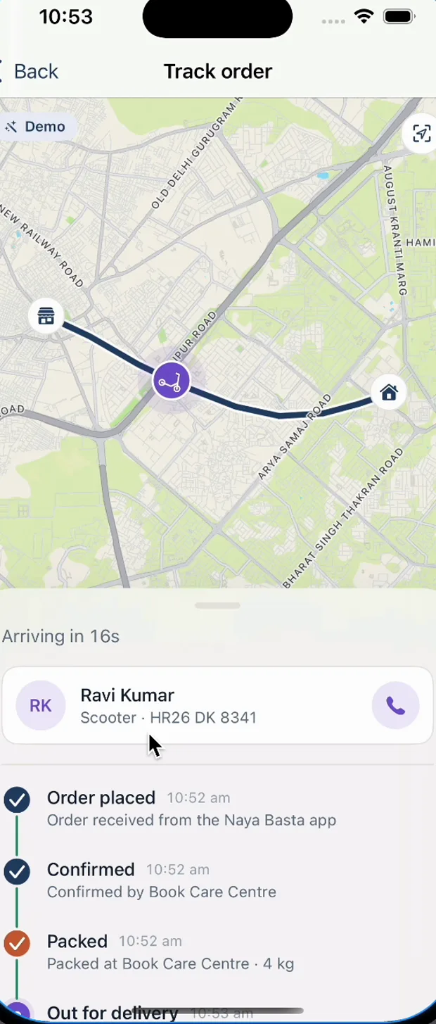 Order tracking screen with the rider en route on a live map between the shop and home